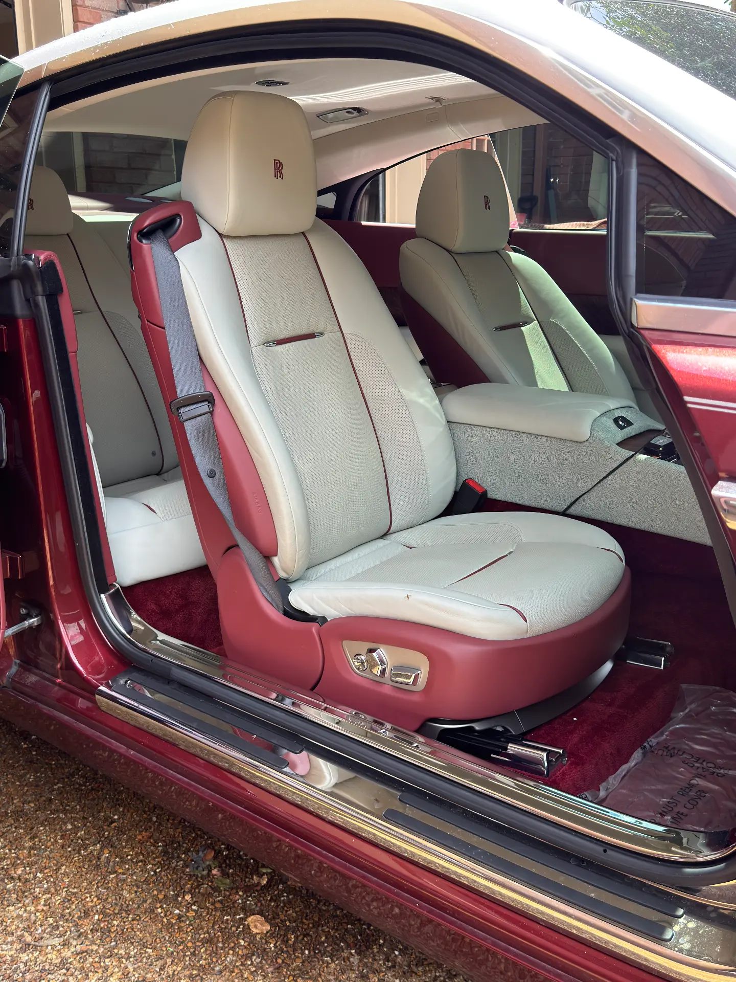 Front cream leather seats and carpet after interior detailing in a Rolls-Royce Wraith