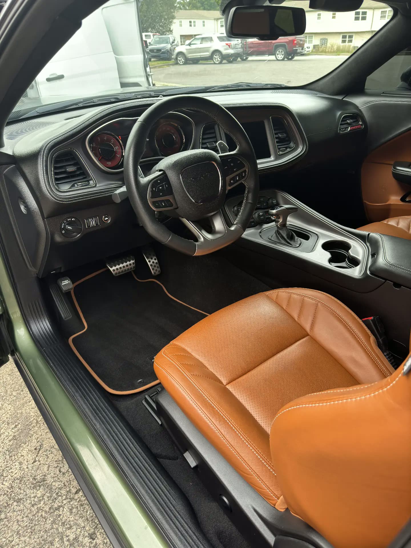 Interior detailing on a Dodge Challenger SRT with brown leather seats