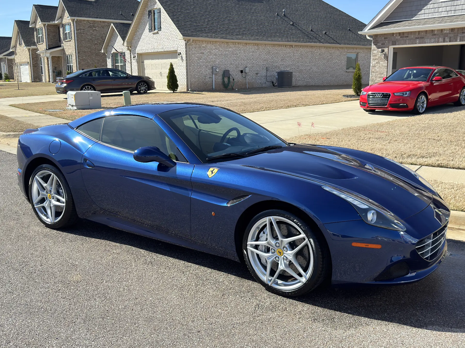 Blue Ferrari California detailed in a residential driveway