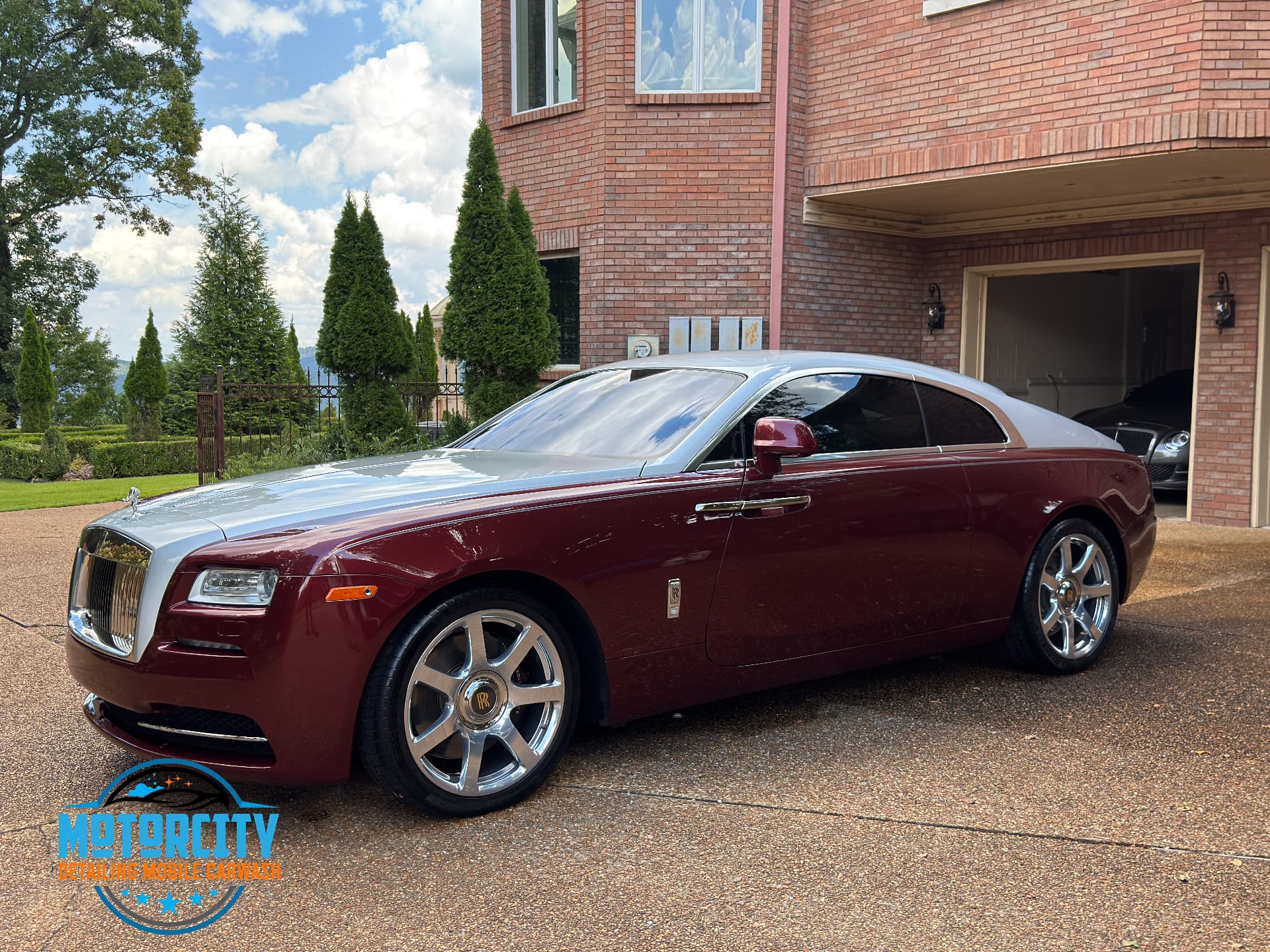 Complete car detailing on a maroon Rolls-Royce Wraith in a driveway